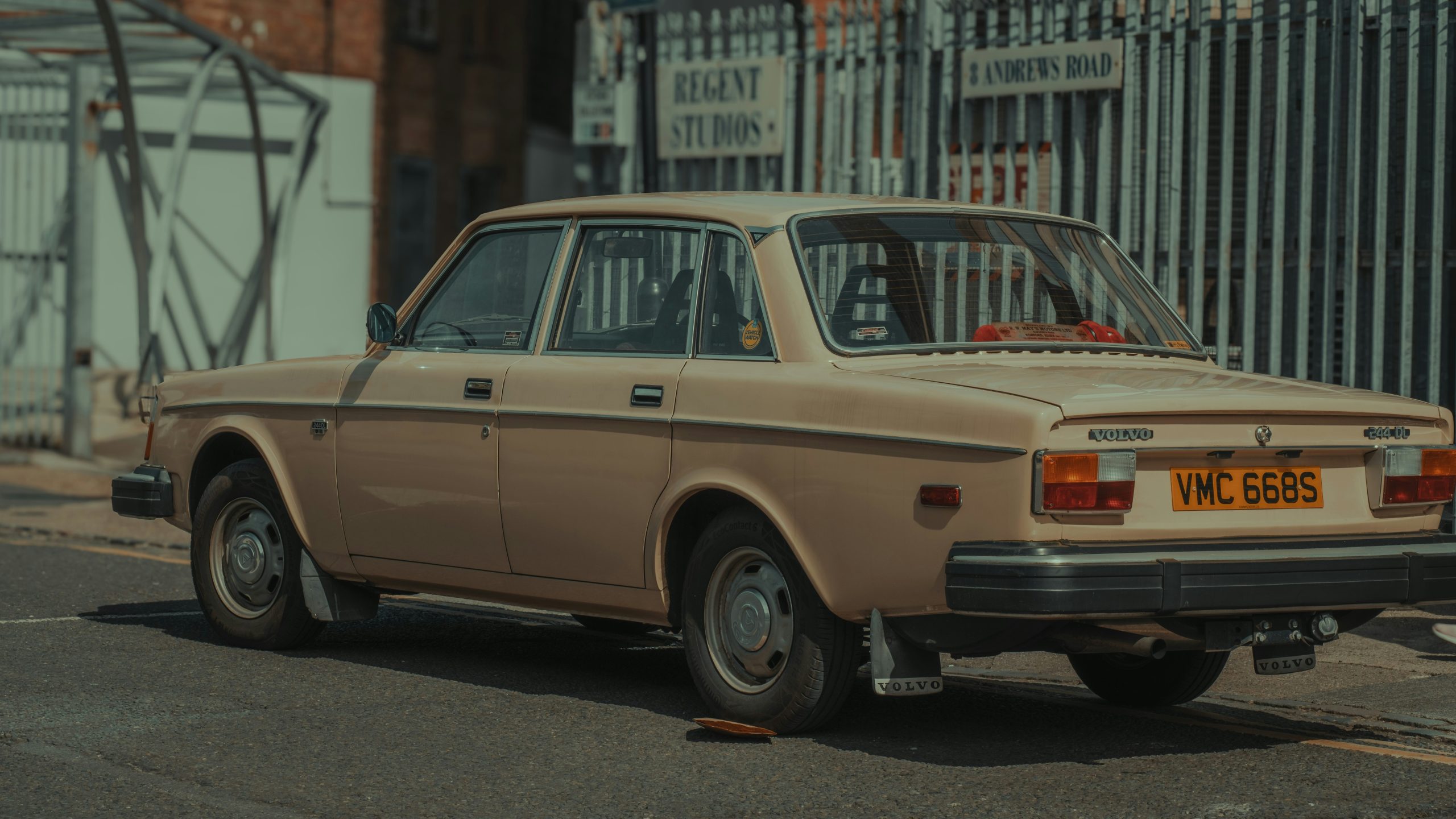 Classic 1970s car parked on the side of a city road, showing retro design and style